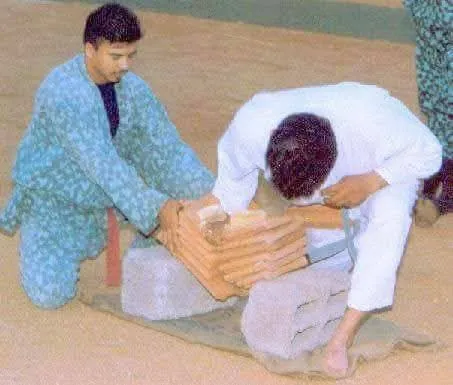 Students preparing a stack of tiles on bricks for a break